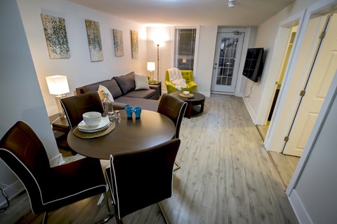 a living room and dining room with a table and chairs